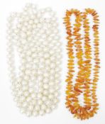 Long string of freshwater pearls and an amber-coloured bead necklace (2)