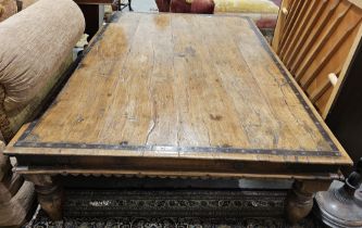 Large iron-bound hardwood coffee table, probably Asian, 20th century, the plank top riveted with