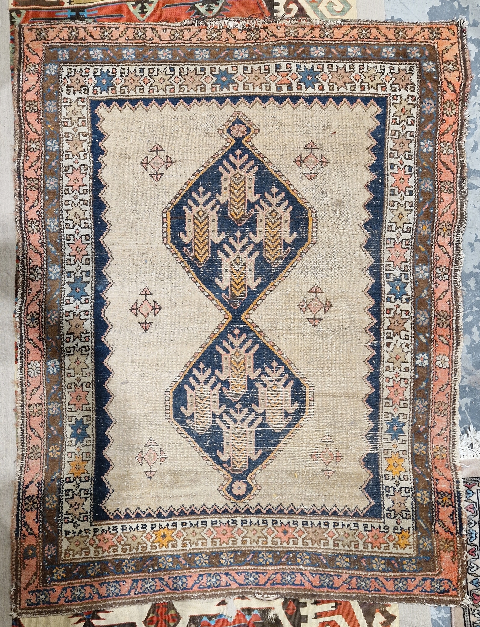 Eastern mushroom ground rug, central panel with joined lozenges to floral borders, 154cm x 110cm