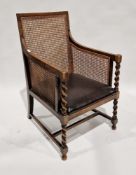 Early 20th century oak bergere caned armchair with drop-in seat and barleytwist supports