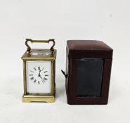 Early 20th century French brass carriage clock, with bevelled glass panels, the white enamel dial