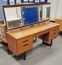 Mid-century teak Uniflex dressing table with folding three-section mirror raised over a single