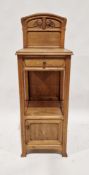 Art Nouveau oak bedside table, carved with convolvulus and whiplash ornament with frieze drawer