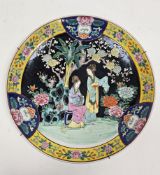 Early 20th century Chinese famille noir charger, decorated with two ladies in a garden before