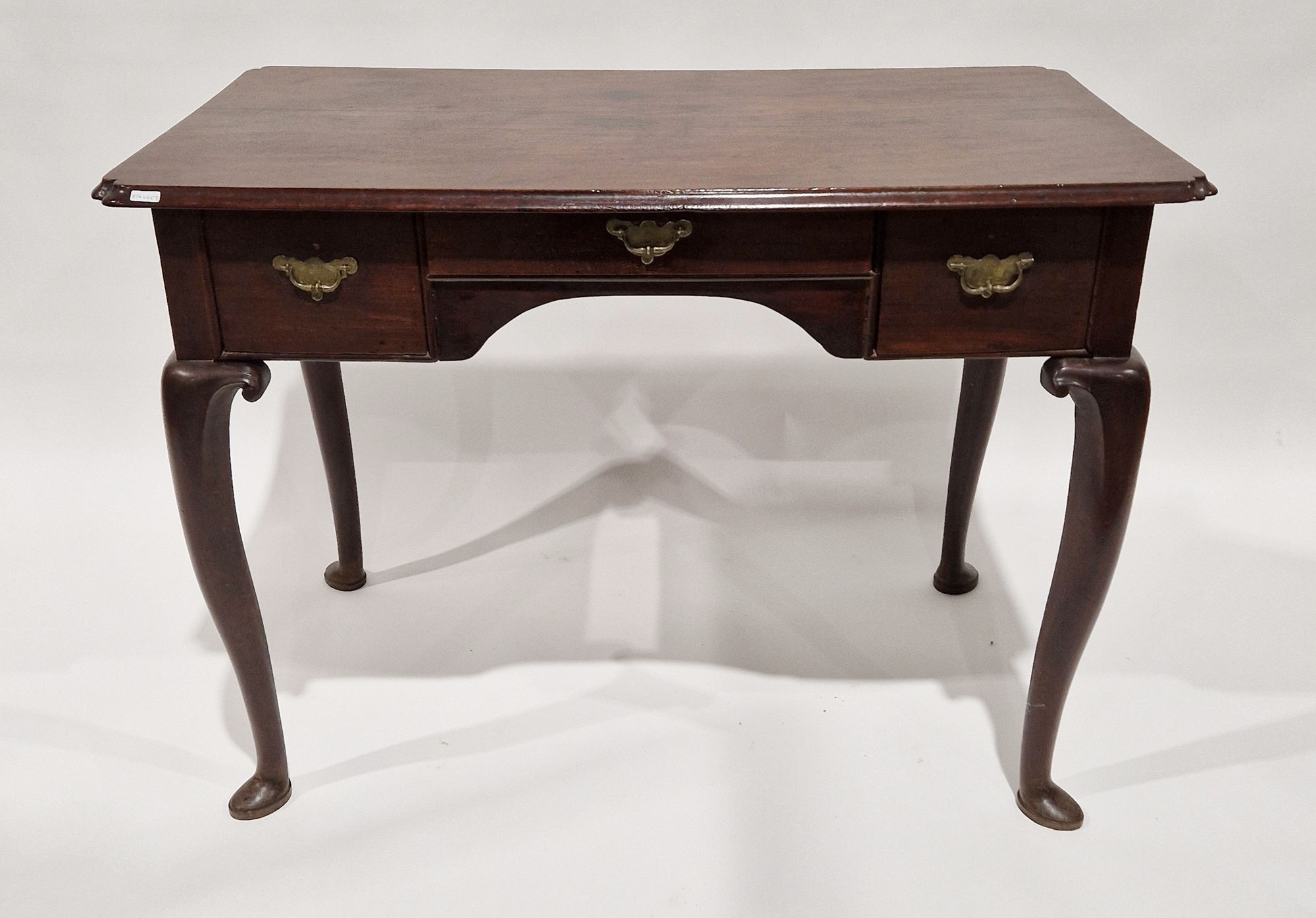 George II mahogany lowboy, the rectangular top with shaped corners, over one long and two short