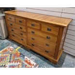 Modern pine chest of drawers comprising four short and six long drawers, each with metal handles,