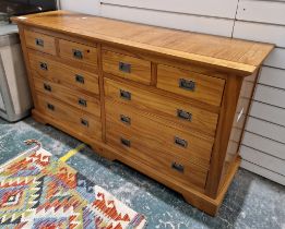 Modern pine chest of drawers comprising four short and six long drawers, each with metal handles,