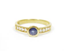 18ct gold ladies sapphire and diamond lady's dress ring, the central sapphire flanked on either side