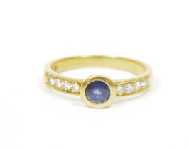 18ct gold ladies sapphire and diamond lady's dress ring, the central sapphire flanked on either side