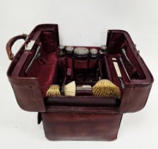 Edwardian red leather travelling gladstone style silver mounted vanity set, containing silver