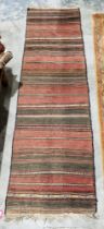 Eastern Mashad red ground wool runner with multiple geometric stripes, 277cm x 75cm