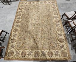 Large Indian wool carpet, the mushroom field with allover scrolling foliate design and with stylised