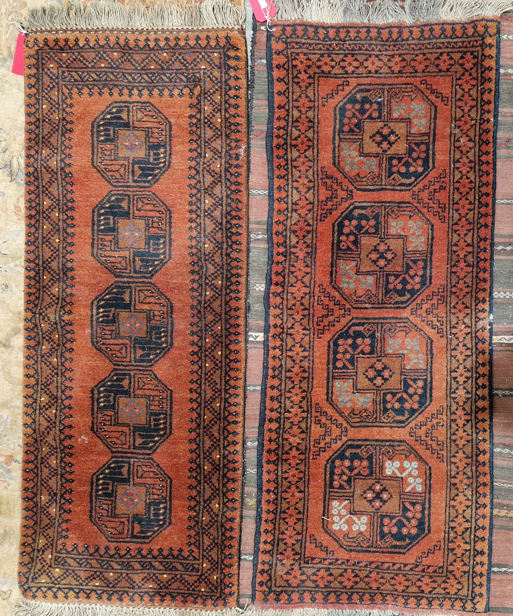 Two Afghani red ground runners, one with four central quartered elephant foot guls to multiple