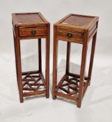 Pair of Chinese hardwood stands of rectangular form, fitted with single drawer and lattice base,