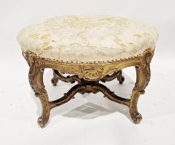 19th century carved giltwood footstool of oval form, on four carved cabriole legs, wavy saltire