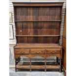 18th century oak dresser with three-tier plate rack over three short drawers, each with brass
