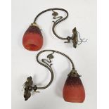 Pair of Art Nouveau brass wall lights with S-shaped tendril branches and lobed wall mounts, with