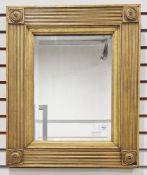 19th century empire style rectangular gilt framed wall mirror with bevelled plate, the reeded