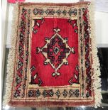 Bokhara rug with single lozenge on a cherry red ground, 24cm x 33cm