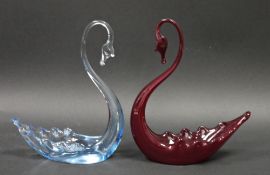 Two Whitefriars glass models of swans, in ruby and pale blue tints, 20.5cm high (2)