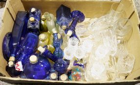 Collection of blue glass cork topped bottles in varying shapes and sizes, blue glass candlesticks, a