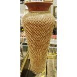 Large floor-standing terracotta vase with woven net covering