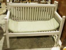 Pair of grey painted garden benches with light green seat covers