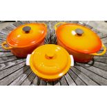 Two orange glazed Le Creuset casserole dishes and a similar example by Cousances (3)