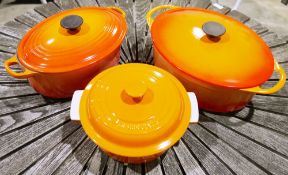Two orange glazed Le Creuset casserole dishes and a similar example by Cousances (3)