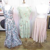 A selection of 1940's and 1950's dresses to include a pale green linen printed with flowers,