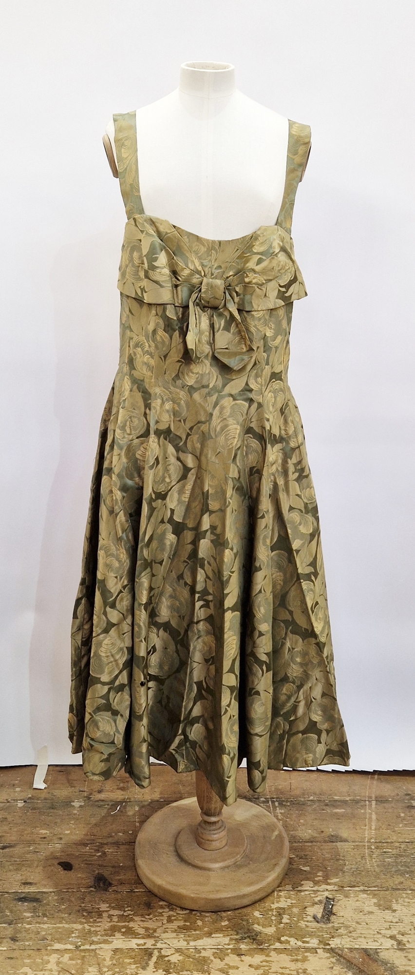 1950's green satin printed cocktail dress, ruched bodice, broad sleeves, bow detail to the front,