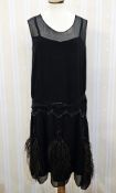 A 1920s black chiffon flapper dress, with faux jet bead decoration to the dropped waist, ostrich
