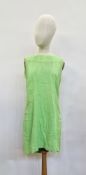 A lime green mini dress, curled ribbon detail to the bodice, scoop back with button and loop