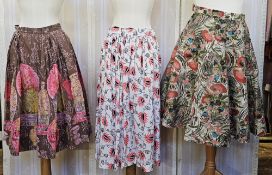 Three 1950's full circle skirts, two cotton with bright print, a stiffened felt full circle skirt