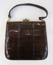 'The Martin' 1950's crocodile handbag with gilt metal ribbed barrel-pattern clasp and having pull-