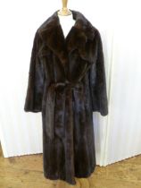 A full length black/brown ranch mink coat with attached mink belt to tie in front. Condition