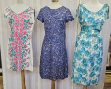 Various 1950's cotton dresses to include a sleeveless white dress printed with pink roses with