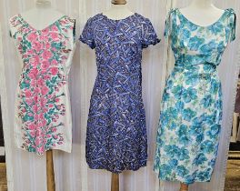 Various 1950's cotton dresses to include a sleeveless white dress printed with pink roses with