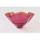 Bob Crooks (b.1965) footed glass bowl, cranberry colourway of scalloped form with amber rim and