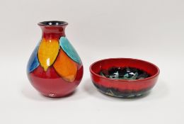 Poole Pottery Delphis vase by Eddie Goodall, multi-coloured leaf shape pattern on red ground,