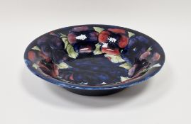 Moorcroft Pansy pattern circular bowl, tube lined with flowerheads, on a cobalt blue ground,