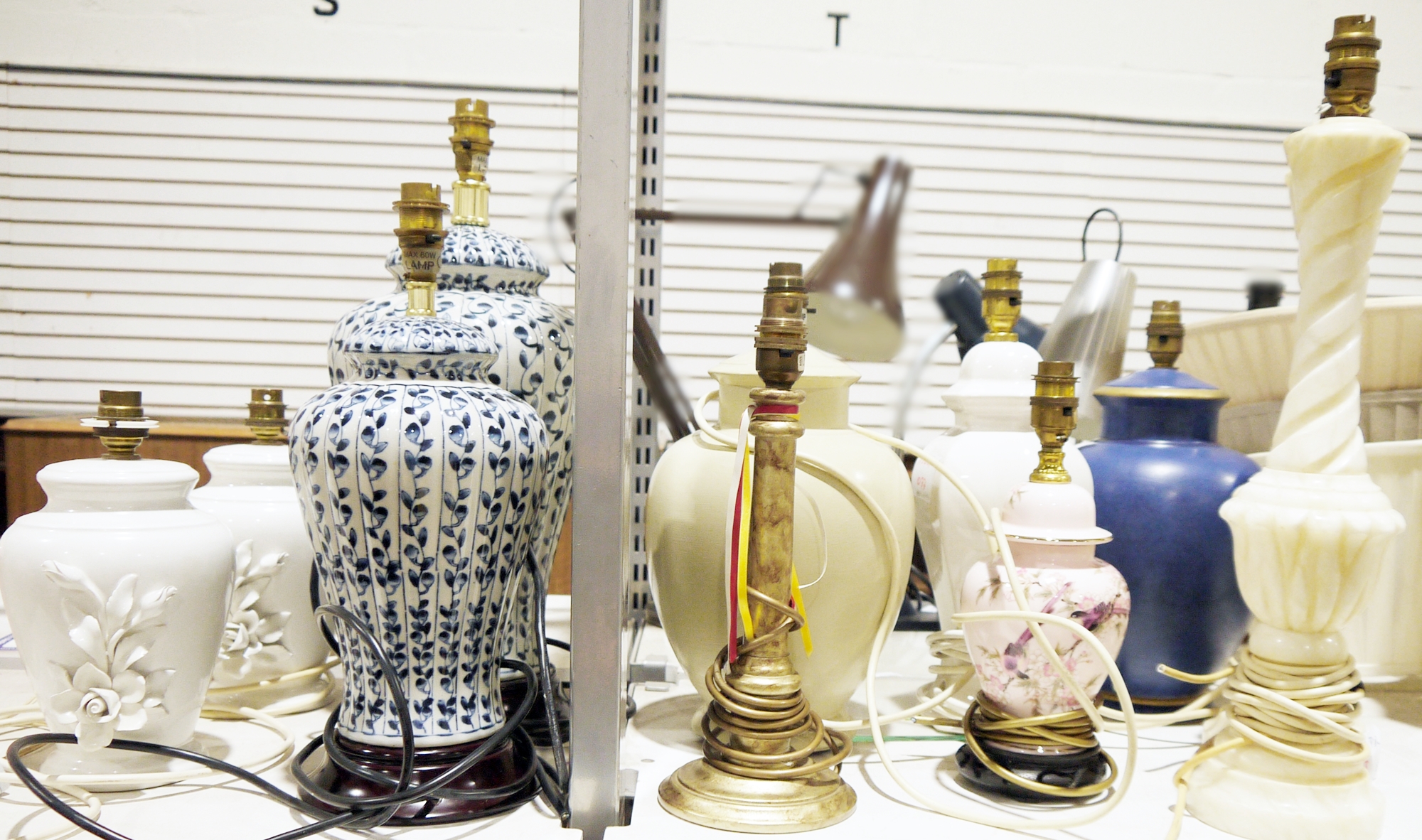 Pair of Marks & Spencer blue and white ceramic vegetable decorated urn-shaped lamps, a pair of white