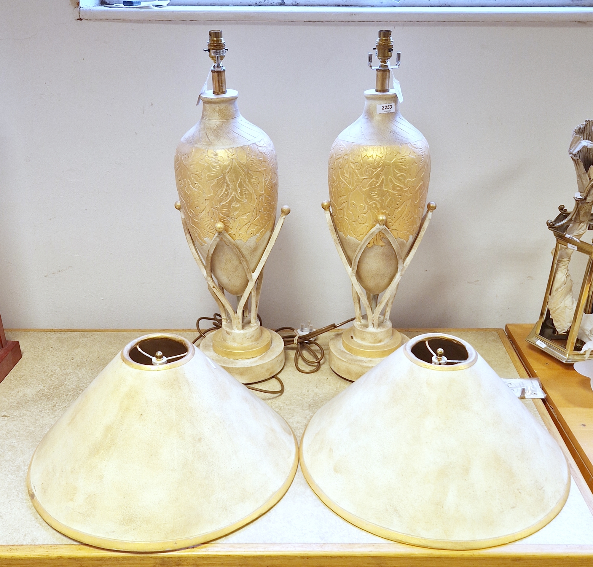 A pair of large contemporary ceramic amphora-shaped table lamps, each incised with foliate strapwork