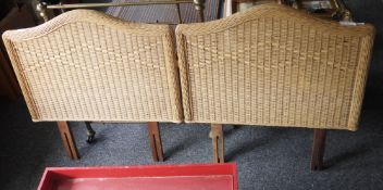 A pair of single wicker headboards and a wooden standard lamp with carved pedestal on circular base