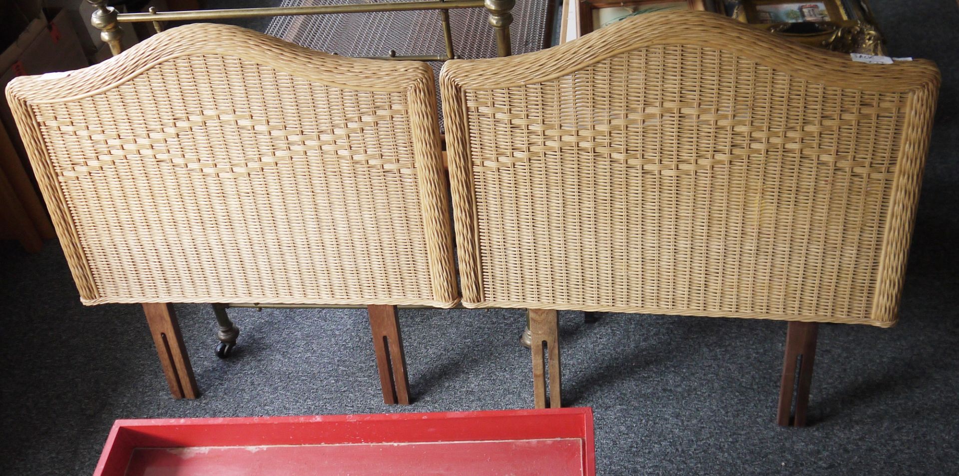 A pair of single wicker headboards and a wooden standard lamp with carved pedestal on circular base