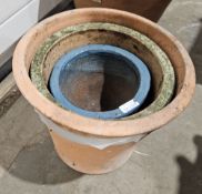 Three terracotta flower pots in sizes, including a blue glazed example, 28cm high max. (3)