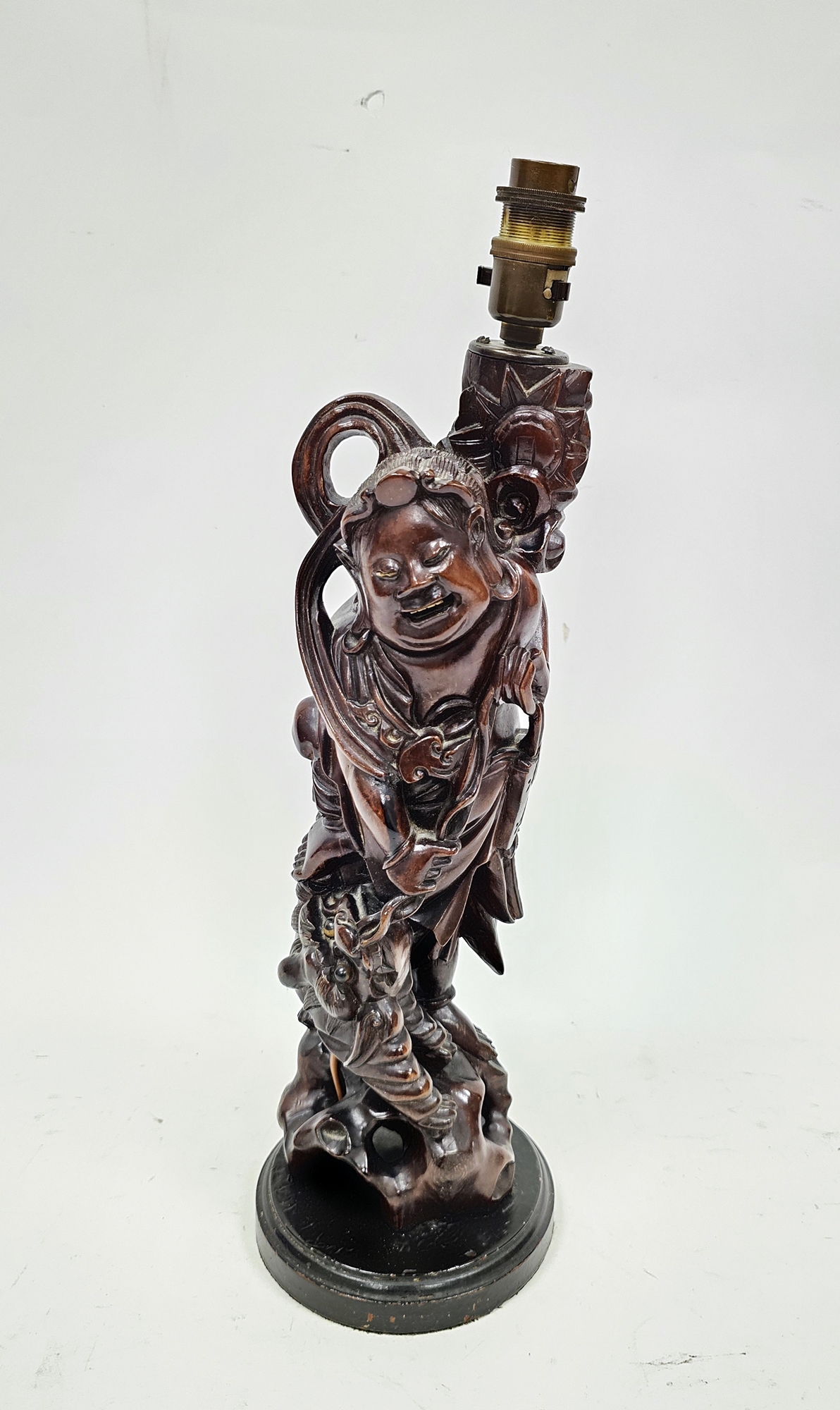 Chinese carved wood figure of an immortal adapted as a table lamp,  modelled standing atop a