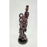 Chinese carved wood figure of an immortal adapted as a table lamp,  modelled standing atop a