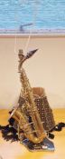 Vintage Majestic saxophone adapted for electricity and mounted as a table lamp on black marble base,