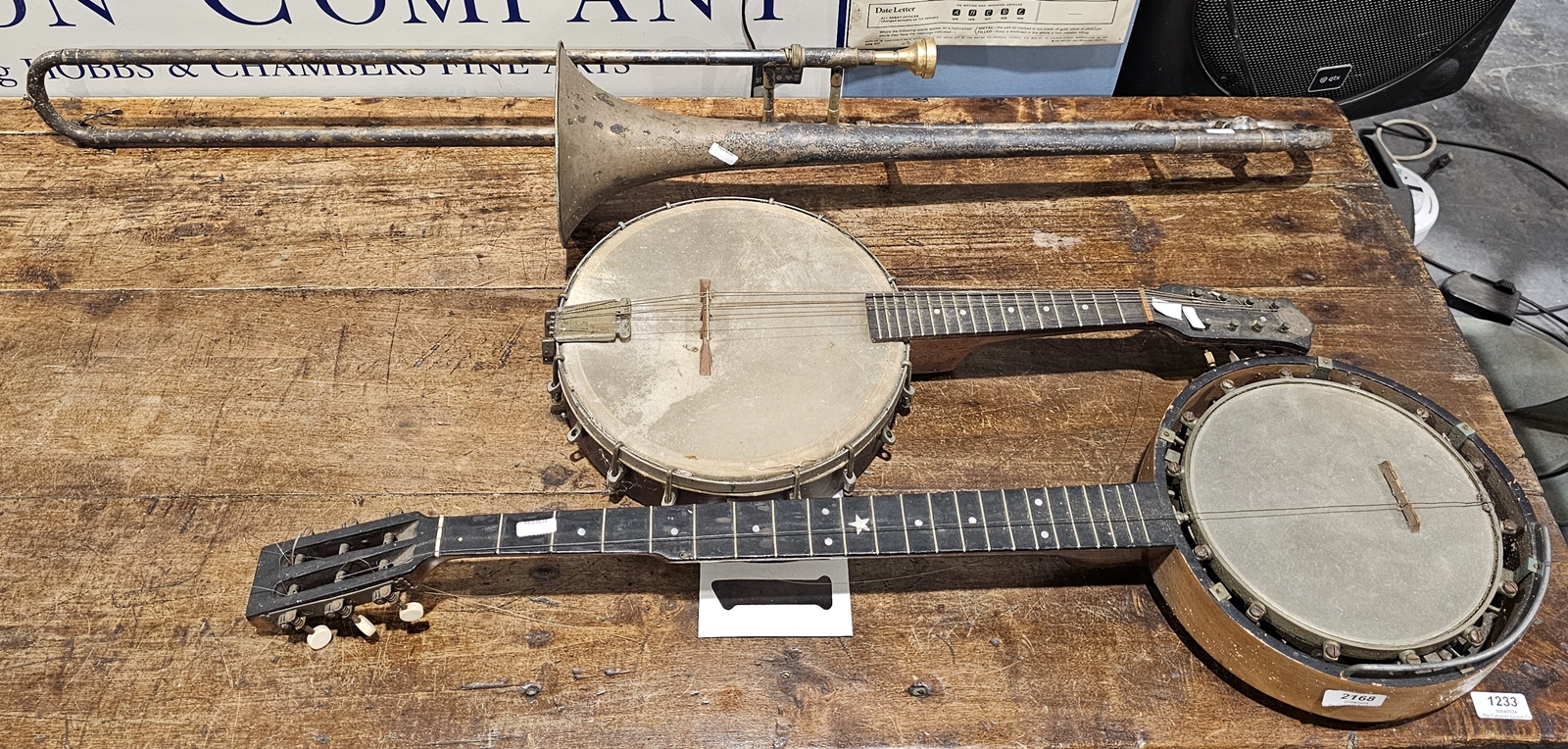 Two vintage banjos and a trombone